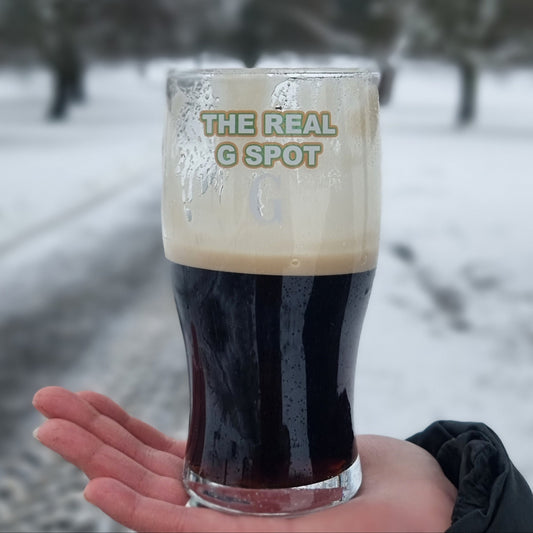 The Real G Spot pint glass filled with stout — split the G funny beer glass gift