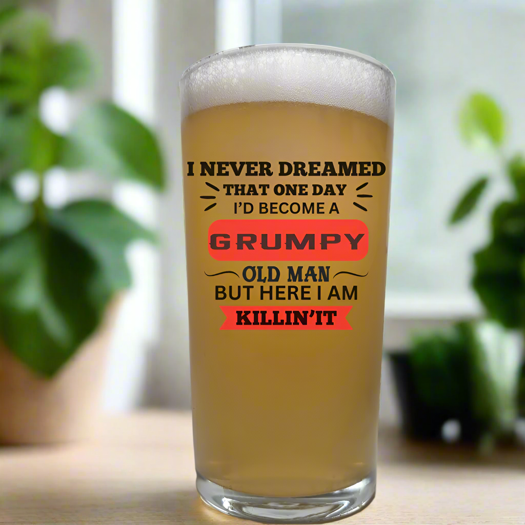 Engraved pint glass with the text “I never dreamed that one day I’d become a grumpy old man but here I am killing it” – funny beer glass gift for men