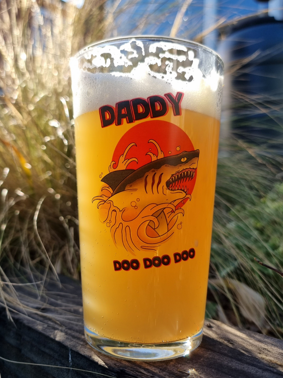 Laser engraved pint glass featuring a shark jumping out of beer with the text “Daddy doo doo doo” – funny Father’s Day beer gift for dads