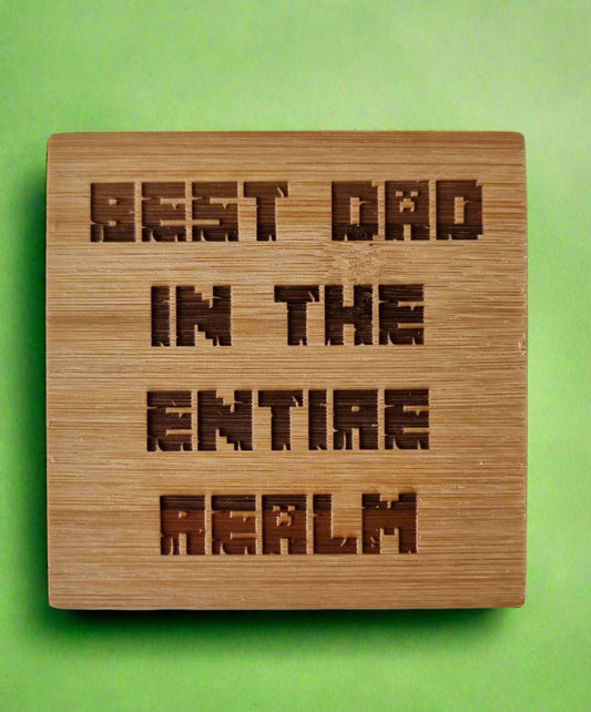 Laser engraved bamboo coaster with “Best Dad in the Entire Realm” text – eco-friendly fantasy-themed Father’s Day gift for dads, rustic drink coaster for coffee or beer