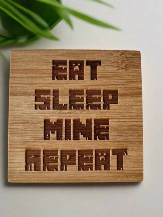 Laser engraved bamboo coaster with “Eat Sleep Mine Repeat” text – Minecraft-inspired eco-friendly gaming gift for kids, teens, and gamer décor