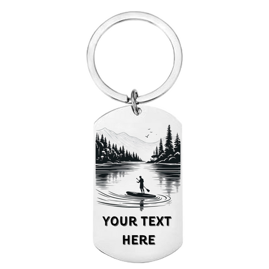 Close up of laser engraved mountain lake paddleboard scene on personalised stainless steel keyring showing female silhouette and custom text