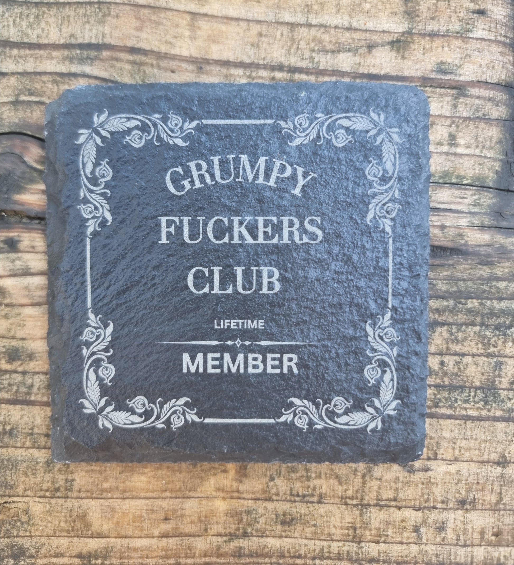 laser engraved slate coaster with “Grumpy Fuckers Club” text and floral border – funny sarcastic drink coaster gift for grumpy people, rustic home or office décor
