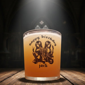 A personalized beer glass with a graphic of two female figures playing guitars and the text 'Happy Birthday Jack' on the side.