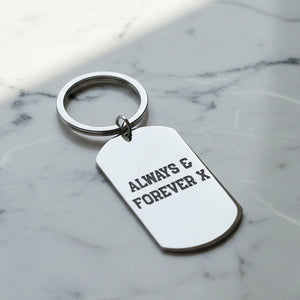 Keychain with 'Always & Forever X' text on a light grey background