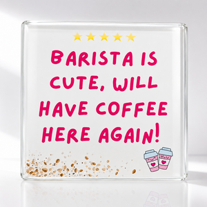A square clear glass coaster with a white printed background featuring the phrase 'BARISTA IS CUTE, WILL HAVE COFFEE HERE AGAIN!' in pink lettering, five yellow stars at the top, coffee beans at the bottom, and two small pink-and-white takeaway coffee cups with hearts.