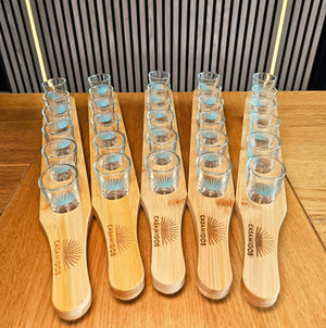 Casamigos tequila shot glasses on a custom wooden engraved shot paddle for barware 