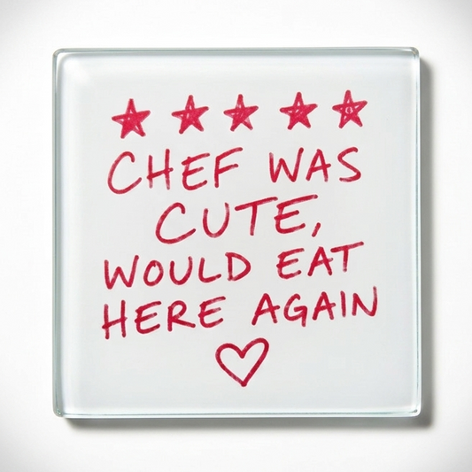 A square glass coaster with a white surface featuring red text that reads 'CHEF WAS CUTE, WOULD EAT HERE AGAIN' with five red stars at the top and a red heart below, shown on a light gray background with a soft glow.