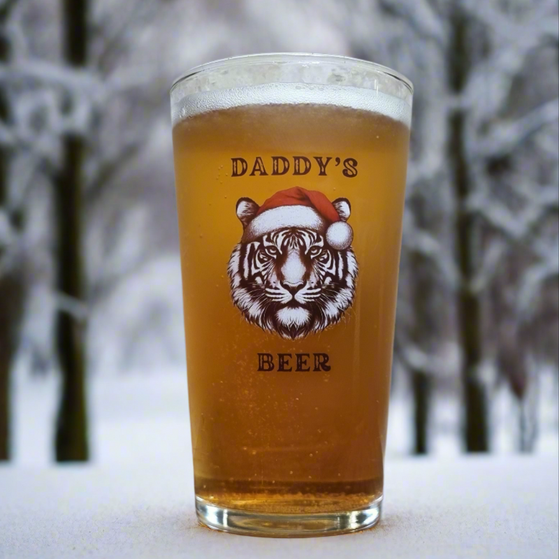 Personalised pint glass printed with a tiger in a Santa hat and the text Daddy's Beer — custom Christmas glassware by First Class Design