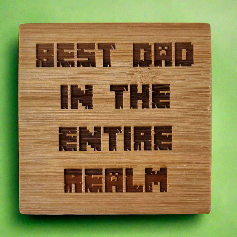 Laser engraved bamboo coaster with “Best Dad in the Entire Realm” text – eco-friendly fantasy-themed Father’s Day gift for dads, rustic drink coaster for coffee or beer