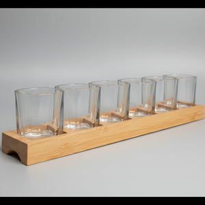Laser engraved bamboo paddle with personalised text, part of custom shot glass set for birthdays, hen dos and parties