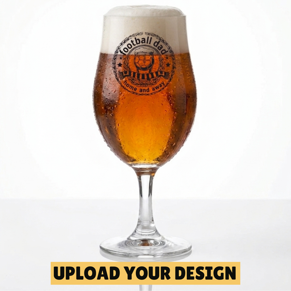 Personalised 568ml chalice pint glass with custom uploaded football dad home and away badge design filled with golden beer on marble surface