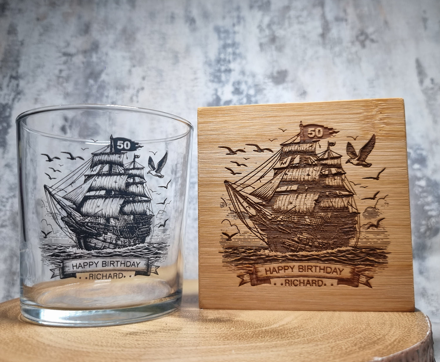 Personalised rum glass with ship design, custom name and age, shown with optional bamboo coaster and varnished wooden gift box – nautical themed gift for him