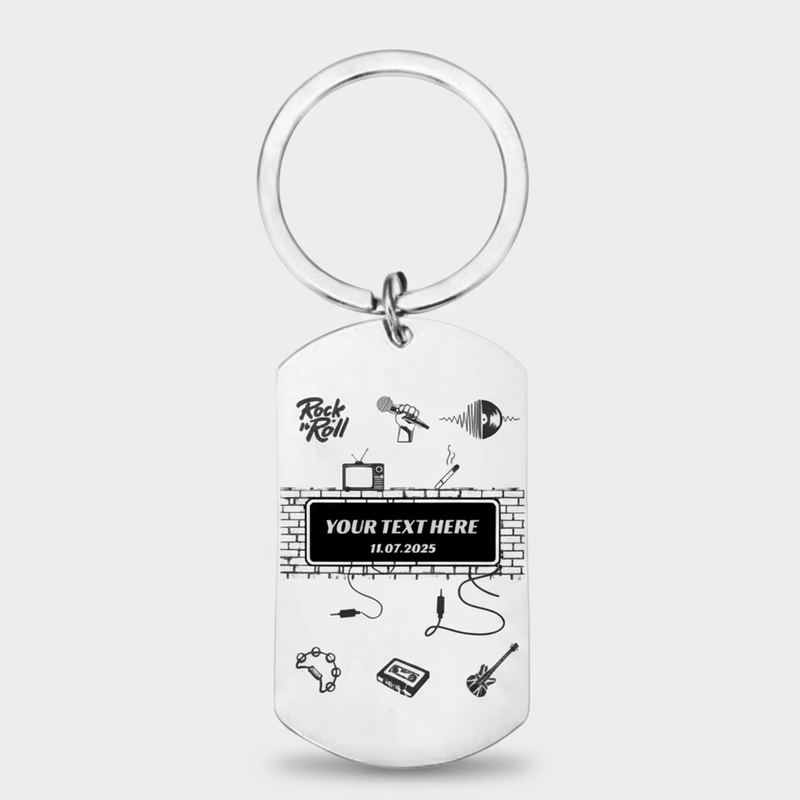 A silver metal dog tag keychain with a circular split ring, featuring black printed graphics of music instruments, a brick wall, and customizable text on a light gray background.