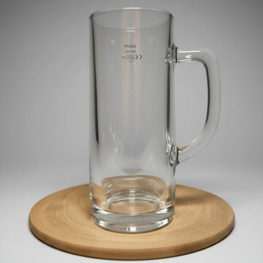 Plain glass pint stein with handle on wooden board — shown blank before custom design is applied, white brick background