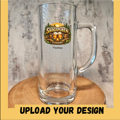 Personalised glass pint stein with handle printed with a custom craft beer logo design and personalised name below — example of uploaded design with text addon, shown on wooden slice