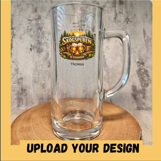 Personalised glass pint stein with handle printed with a custom craft beer logo design and personalised name below — example of uploaded design with text addon, shown on wooden slice