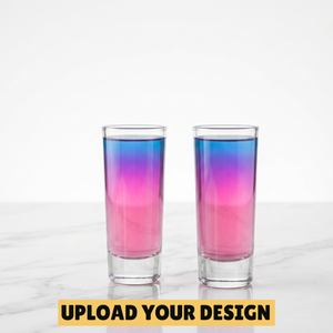Personalised set of two 60ml tall shot glasses filled with pink and blue layered cocktail on marble surface, unique party gift