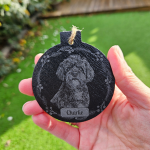 Personalised slate Christmas bauble laser engraved with an uploaded dog photo in a wreath design and the name Charlie