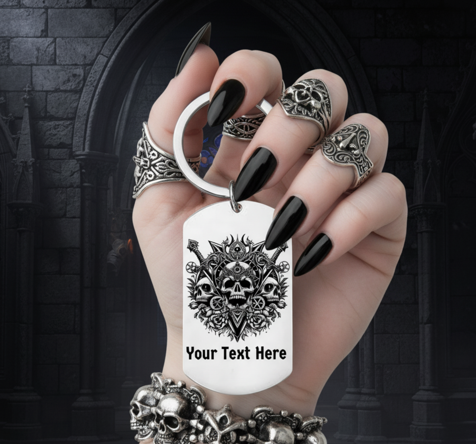 Hand holding a keychain with a skull design and customizable text, against a dark background.