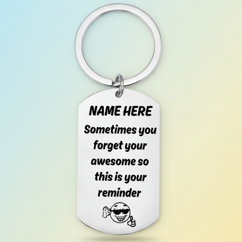 Personalised 'you're awesome' keyring with custom name placeholder, displaying the message 'Sometimes you forget your awesome so this is your reminder' with a smiling character wearing sunglasses