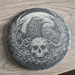 Close up of intricate laser engraved raven and skull gothic design on premium natural slate coaster showing extraordinary detail