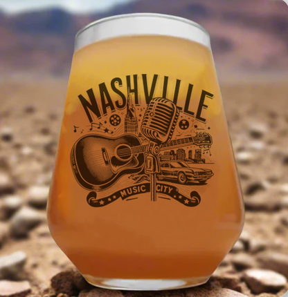 Monochrome line art of a retro-style guitar and vintage microphone, with bold lettering that reads 'Nashville Music City'. Designed in a classic, old-school style perfect for country and rock 'n' roll fans.