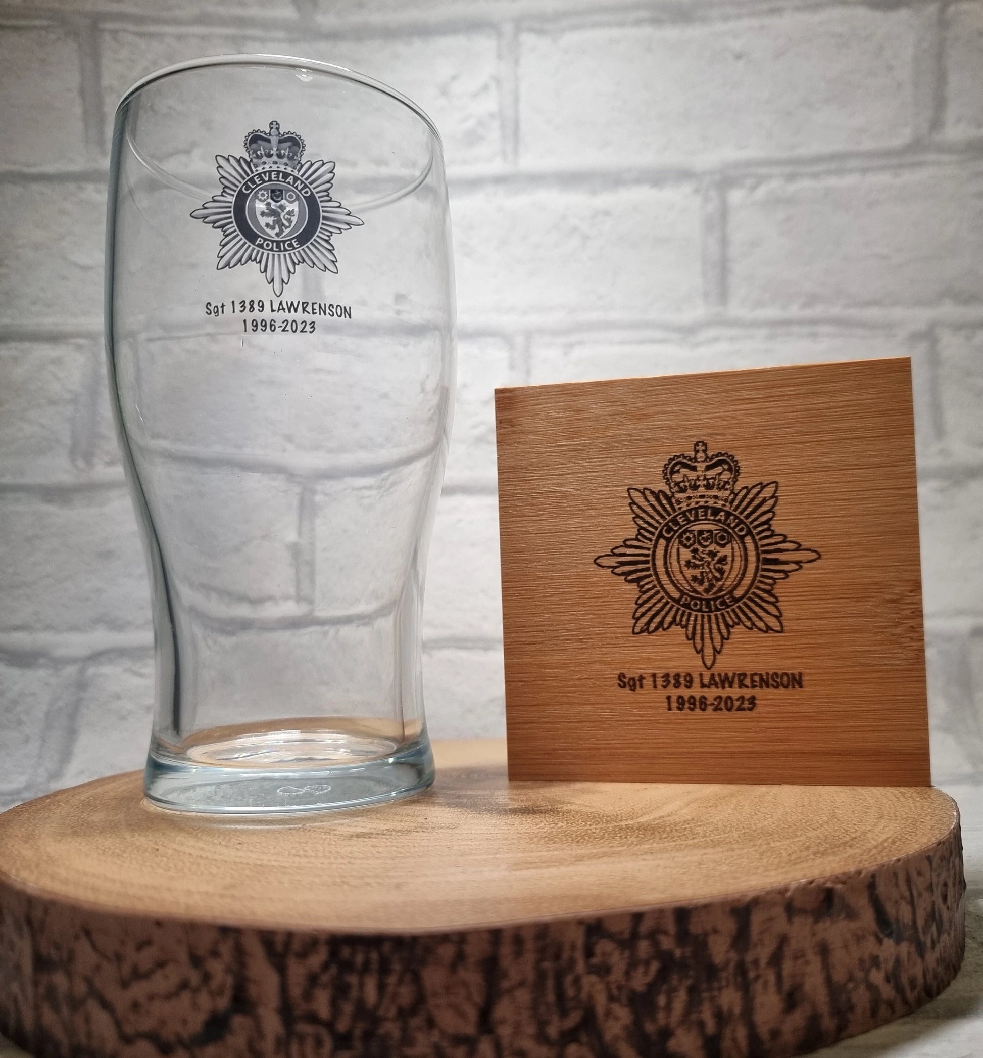Personalised police pint glass and bamboo coaster set showing custom force logo and officer details
