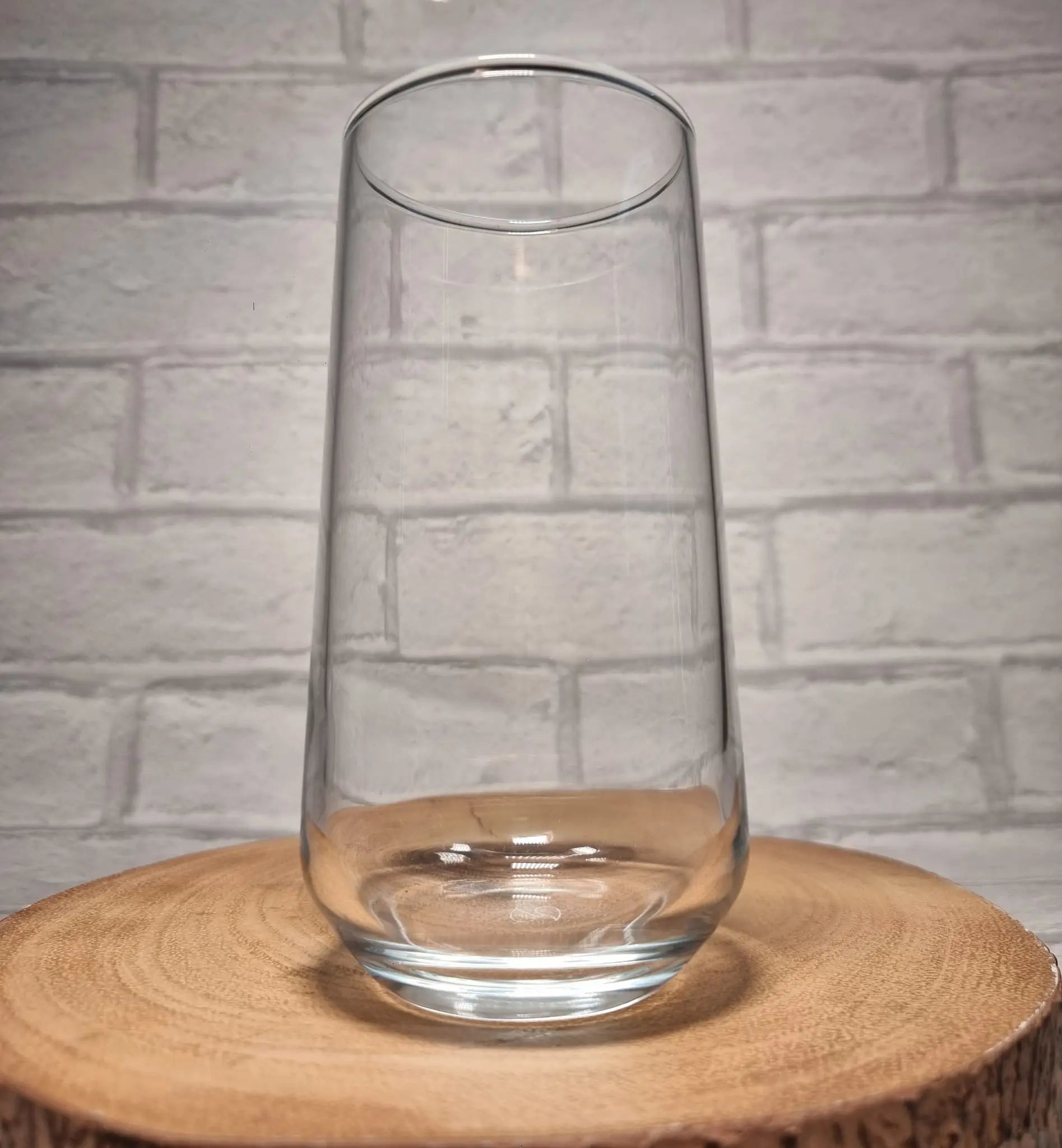 Close up of custom printed circular design on personalised stemless glass showing name and hobby artwork